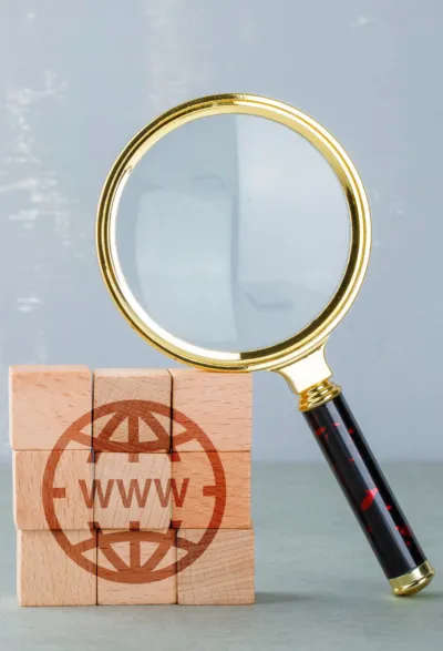 Conceptual internet search with wooden blocks with internet icon magnifying glass side view